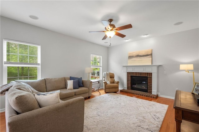 6412 Interlaken Dr, South Fayette, PA 15057 - living room with a ceiling fan, a brick fireplace, and wood finished floors