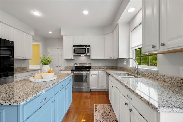 6412 Interlaken Dr, South Fayette, PA 15057 - kitchen featuring appliances with stainless steel finishes, blue cabinets, white cabinets, recessed lighting, and wood finished floors