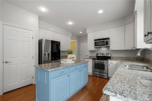 6412 Interlaken Dr, South Fayette, PA 15057 - kitchen with stainless steel appliances, a kitchen island, light stone countertops, white cabinets, and recessed lighting