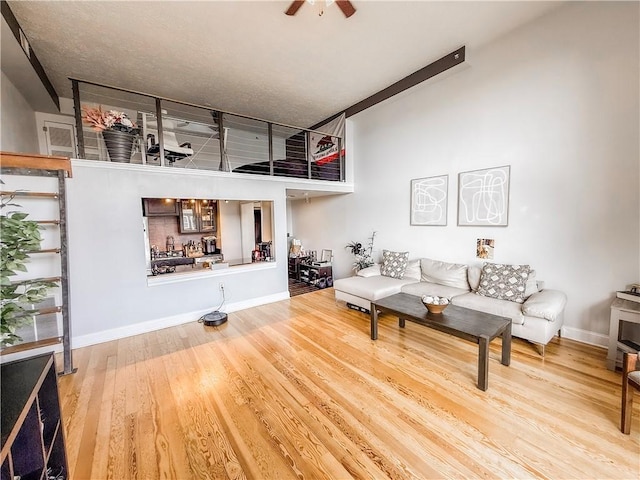 66 Pius St Unit 103, South Side, PA 15203 - living room with wood finished floors, ceiling fan, and a high ceiling