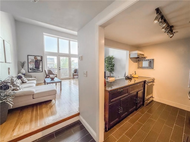 66 Pius St Unit 103, South Side, PA 15203 - bar area with appliances with stainless steel finishes, dark wood-style floors, ventilation hood, and track lighting