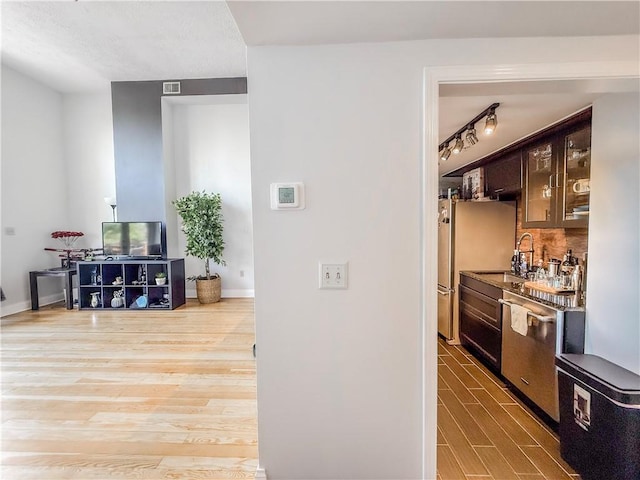 66 Pius St Unit 103, South Side, PA 15203 - bar area featuring appliances with stainless steel finishes, wood finished floors, and decorative backsplash