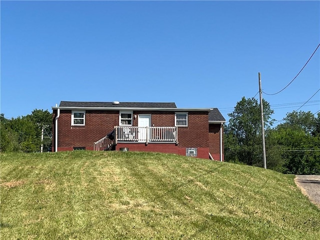 2103 Vermont Ave, West Mifflin, PA 15122 - back of house featuring a lawn, brick siding, and a wooden deck
