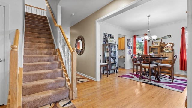 1025 Brookfield Dr, Bethel Park, PA 15102 - dining space featuring a chandelier, stairs, light wood finished floors, and ornamental molding