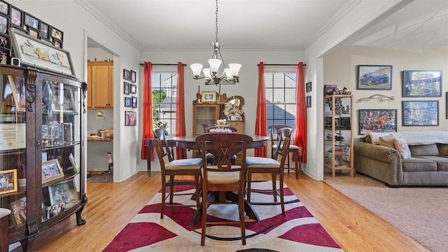 1025 Brookfield Dr, Bethel Park, PA 15102 - dining area featuring a chandelier, plenty of natural light, light wood-style flooring, and ornamental molding