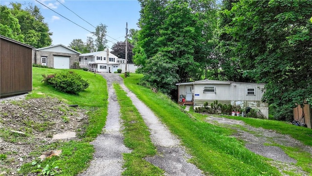 468 Crest Dr, Delmont, PA 15626 - exterior space featuring driveway, an outbuilding, and a detached garage