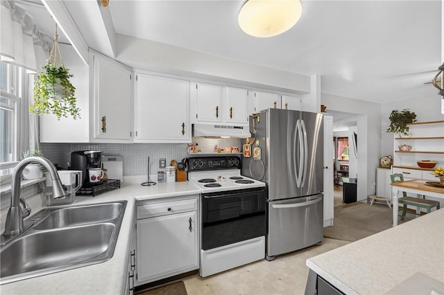 468 Crest Dr, Delmont, PA 15626 - kitchen featuring white range with electric cooktop, freestanding refrigerator, under cabinet range hood, light countertops, and backsplash