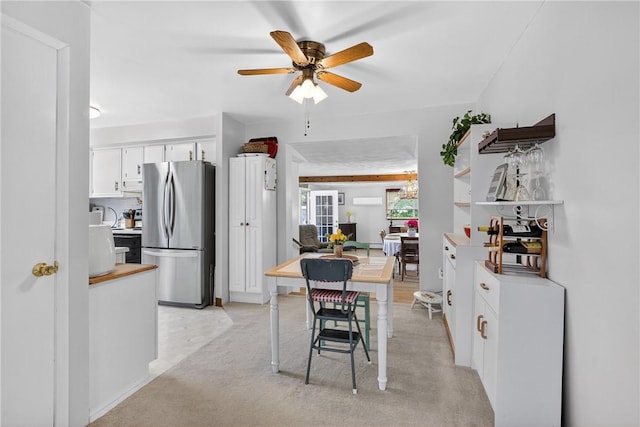 468 Crest Dr, Delmont, PA 15626 - kitchen featuring freestanding refrigerator, white cabinetry, a ceiling fan, light countertops, and light carpet