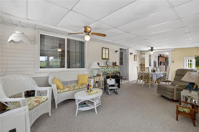 468 Crest Dr, Delmont, PA 15626 - living area with ceiling fan, a paneled ceiling, carpet floors, and wood walls
