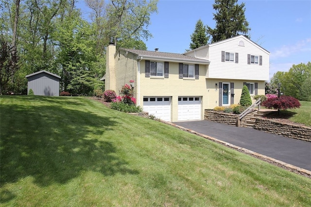 1351 Sky Ridge Dr, Upper St Clair, PA 15241 - split level home featuring a chimney, asphalt driveway, an attached garage, and a front lawn
