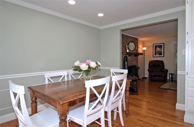 1351 Sky Ridge Dr, Upper St Clair, PA 15241 - dining room with light wood-type flooring, a brick fireplace, ornamental molding, and recessed lighting
