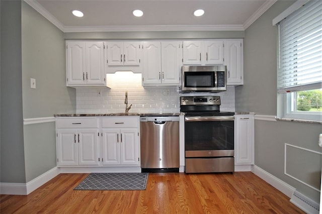 1351 Sky Ridge Dr, Upper St Clair, PA 15241 - kitchen with appliances with stainless steel finishes, light wood-style flooring, decorative backsplash, white cabinetry, and recessed lighting