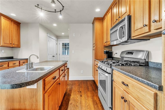 1659 Hooker Rd, Pa, PA 16041 - kitchen featuring stainless steel appliances, dark wood-style flooring, dark countertops, a center island with sink, and recessed lighting