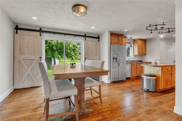 1659 Hooker Rd, Pa, PA 16041 - kitchen featuring a barn door, stainless steel appliances, recessed lighting, light wood finished floors, and a textured ceiling