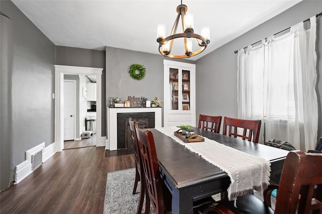 503 E Murphy Ave, Connellsville, PA 15425 - dining room with a chandelier, dark wood-type flooring, and a fireplace with flush hearth