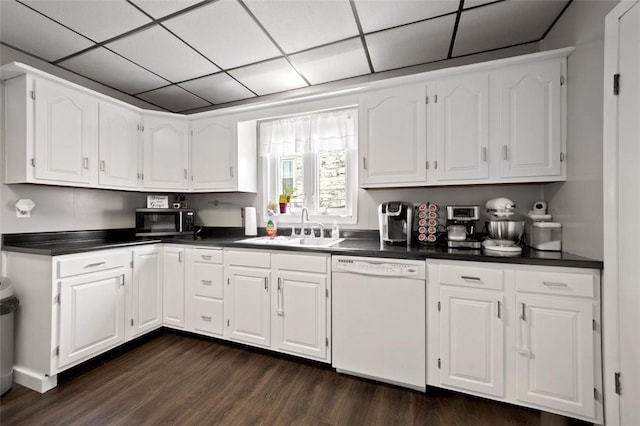 503 E Murphy Ave, Connellsville, PA 15425 - kitchen featuring white dishwasher, dark countertops, dark wood-style floors, white cabinets, and a drop ceiling