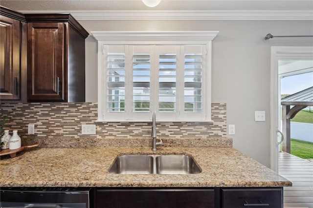 108 Norfolk Dr, Buffalo Twp But, PA 16055 - kitchen with dark brown cabinets, dishwashing machine, tasteful backsplash, ornamental molding, and light stone countertops