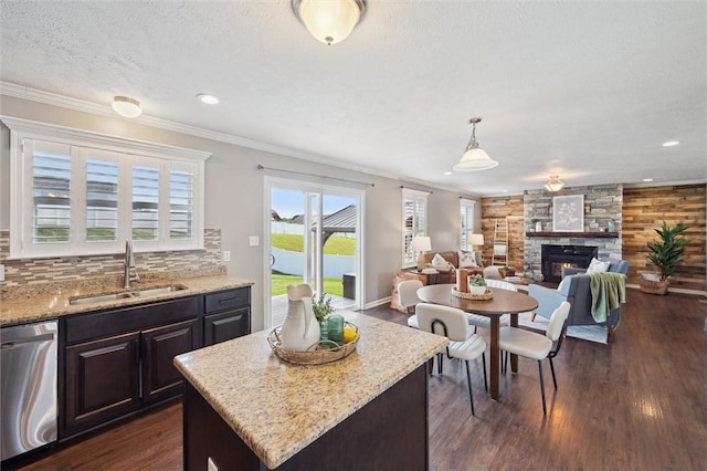108 Norfolk Dr, Buffalo Twp But, PA 16055 - kitchen with stainless steel dishwasher, dark wood-type flooring, decorative backsplash, a fireplace, and light stone counters