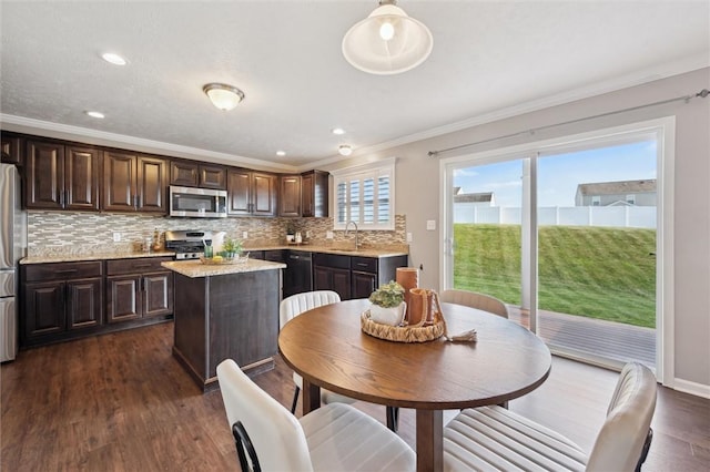 108 Norfolk Dr, Buffalo Twp But, PA 16055 - kitchen with appliances with stainless steel finishes, dark brown cabinets, ornamental molding, dark wood-type flooring, and tasteful backsplash