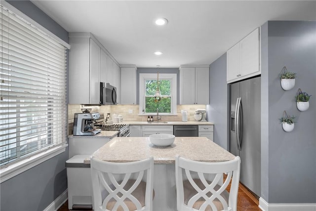 727 Vermont Ave, Mt Lebanon, PA 15234 - kitchen featuring stainless steel appliances, backsplash, white cabinets, a breakfast bar, and recessed lighting
