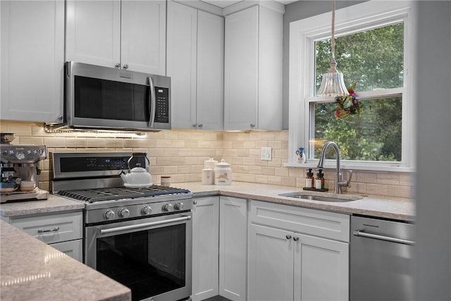 727 Vermont Ave, Mt Lebanon, PA 15234 - kitchen featuring appliances with stainless steel finishes, white cabinetry, backsplash, and light stone countertops