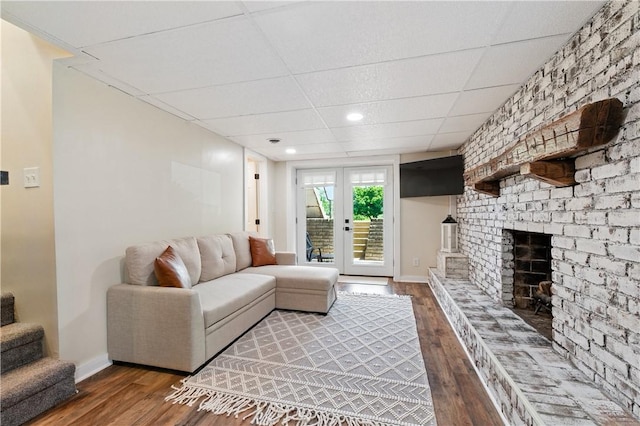 1100 Algonquin Dr, Robinson Twp, PA 15205 - living room featuring wood-type flooring, a drop ceiling, a brick fireplace, and stairway