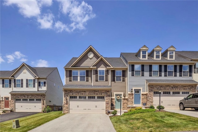 1006 Callaway Dr, Jeannette, PA 15644 - townhome / multi-family property featuring driveway, a garage, a front lawn, and stone siding