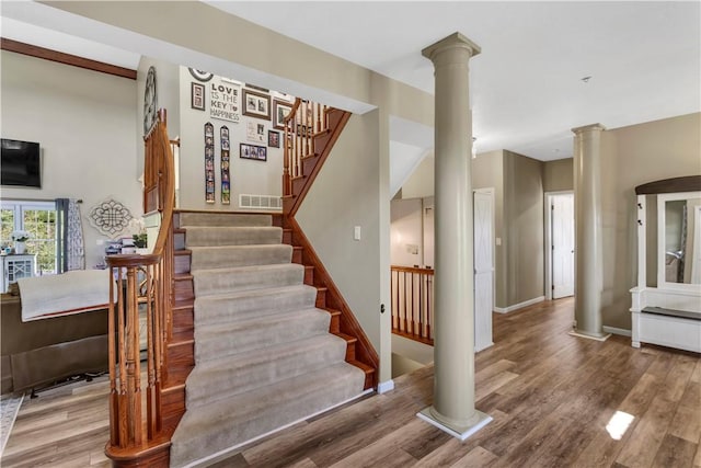 245 Shaw Ct, Salem Twp Wml, PA 15670 - stairs with ornate columns and wood finished floors
