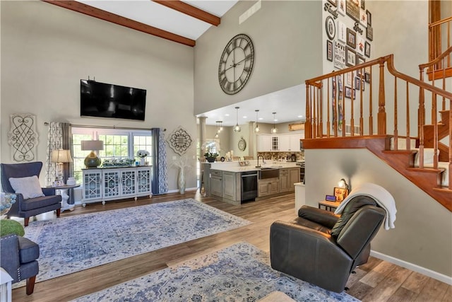 245 Shaw Ct, Salem Twp Wml, PA 15670 - living room featuring high vaulted ceiling, beam ceiling, stairs, and light wood-style floors
