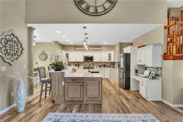 245 Shaw Ct, Salem Twp Wml, PA 15670 - kitchen featuring stainless steel microwave, freestanding refrigerator, decorative backsplash, an island with sink, and recessed lighting