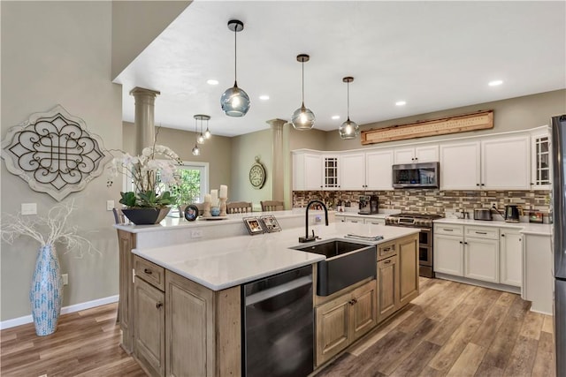 245 Shaw Ct, Salem Twp Wml, PA 15670 - kitchen with appliances with stainless steel finishes, ornate columns, decorative backsplash, light wood-style flooring, and recessed lighting