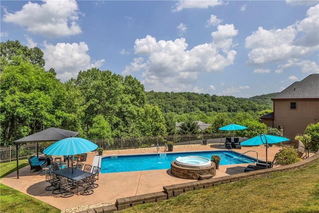 245 Shaw Ct, Salem Twp Wml, PA 15670 - view of swimming pool with a patio area, an in-ground hot tub, and a view of trees