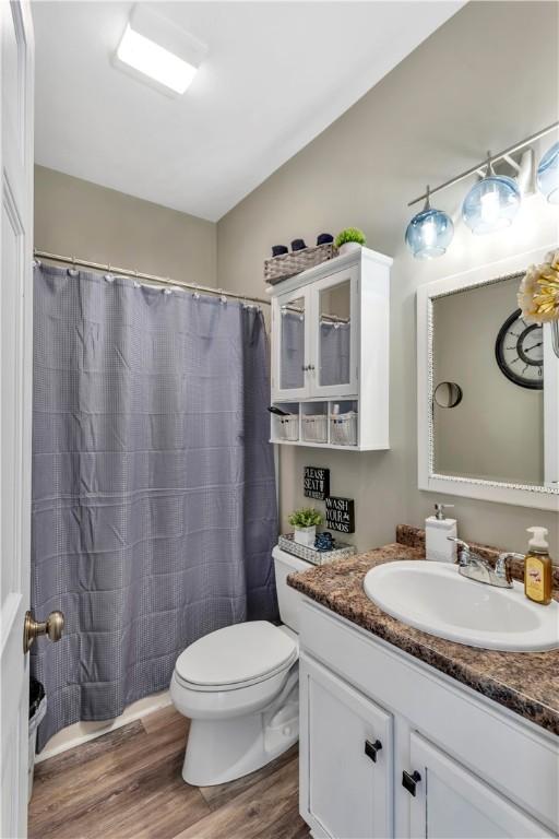 245 Shaw Ct, Salem Twp Wml, PA 15670 - full bathroom featuring vanity, wood finished floors, and curtained shower