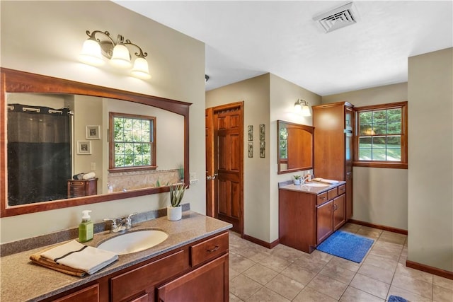 245 Shaw Ct, Salem Twp Wml, PA 15670 - full bath featuring plenty of natural light, two vanities, and tile patterned flooring