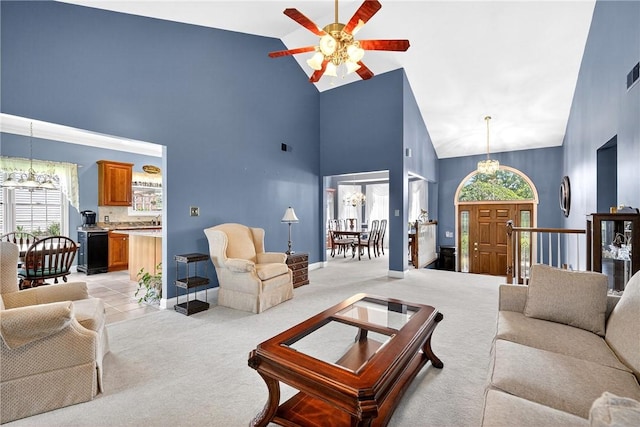 260 Arrowhead Ln, Nottingham, PA 15330 - living room with high vaulted ceiling, a ceiling fan, a chandelier, and light colored carpet