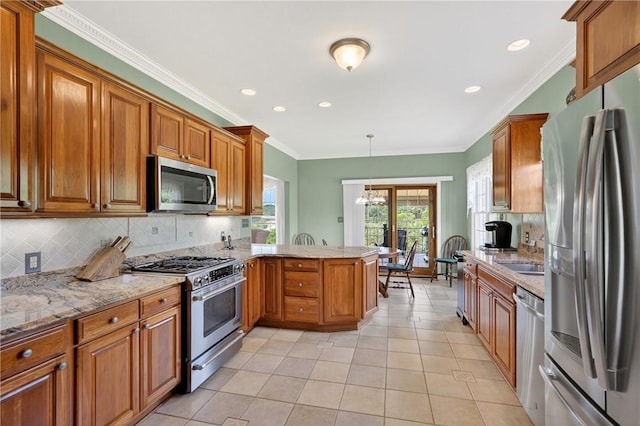 260 Arrowhead Ln, Nottingham, PA 15330 - kitchen featuring appliances with stainless steel finishes, a peninsula, brown cabinets, decorative backsplash, and recessed lighting