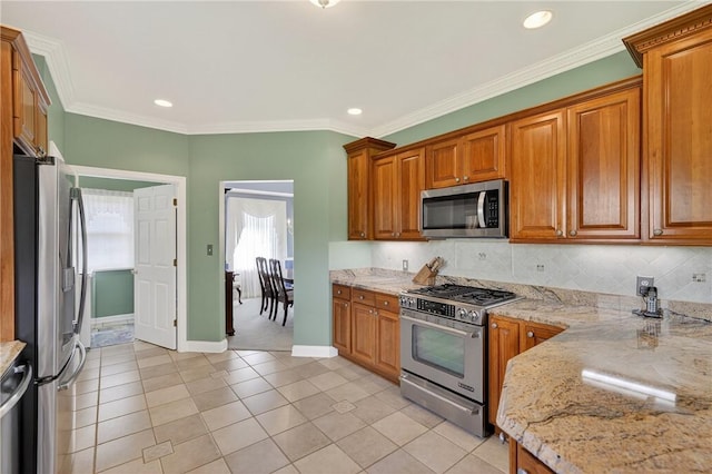 260 Arrowhead Ln, Nottingham, PA 15330 - kitchen featuring appliances with stainless steel finishes, light stone counters, brown cabinets, decorative backsplash, and light tile patterned flooring