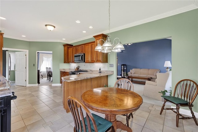 260 Arrowhead Ln, Nottingham, PA 15330 - kitchen with stainless steel appliances, light tile patterned floors, brown cabinetry, recessed lighting, and a chandelier