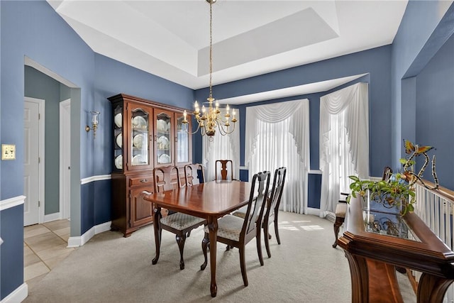 260 Arrowhead Ln, Nottingham, PA 15330 - dining area featuring a chandelier, light colored carpet, a tray ceiling, and light tile patterned flooring
