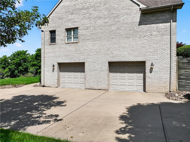 260 Arrowhead Ln, Nottingham, PA 15330 - view of side of property with an attached garage, brick siding, and concrete driveway