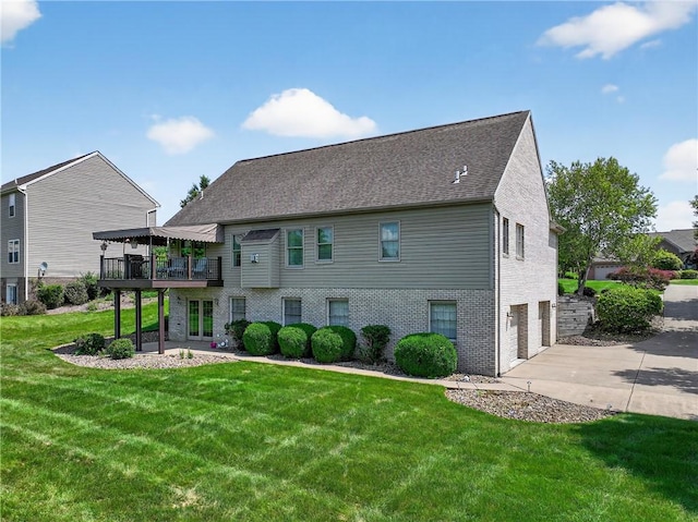 260 Arrowhead Ln, Nottingham, PA 15330 - rear view of house featuring an attached garage, a lawn, brick siding, concrete driveway, and a wooden deck