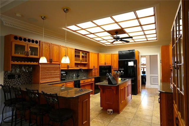 434 Bocktown Cork Rd, Independence Bea, PA 15026 - kitchen featuring crown molding, black fridge, a peninsula, brown cabinetry, and glass insert cabinets