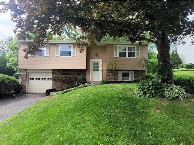 314 Wren Dr, Hempfield Twp Wml, PA 15601 - raised ranch with a garage, driveway, a front lawn, and brick siding