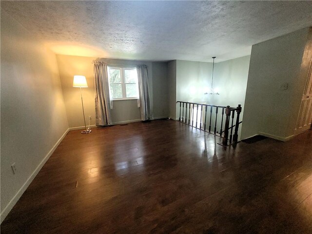 314 Wren Dr, Hempfield Twp Wml, PA 15601 - empty room with a textured ceiling, wood finished floors, and a chandelier