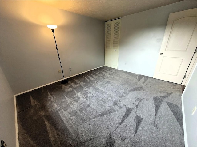 314 Wren Dr, Hempfield Twp Wml, PA 15601 - unfurnished bedroom with dark colored carpet, a closet, and a textured ceiling