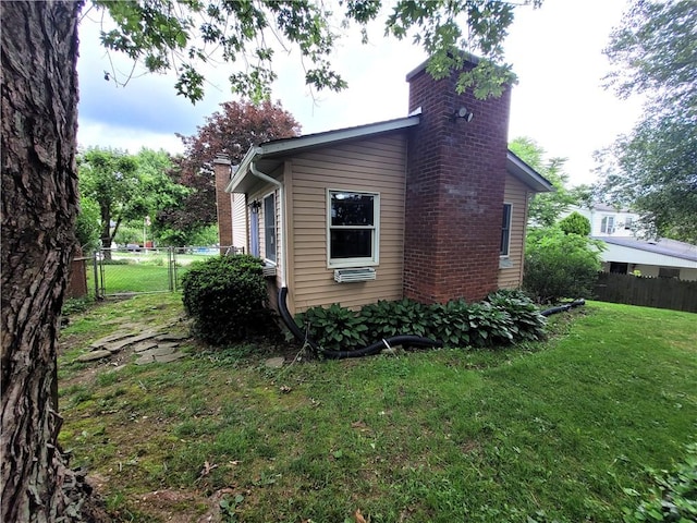 314 Wren Dr, Hempfield Twp Wml, PA 15601 - view of side of home featuring a chimney and a gate