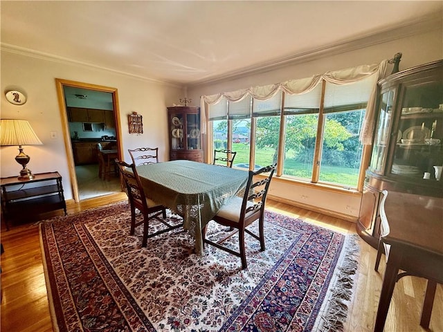 1180 Sunset Dr, Latrobe, PA 15650 - dining area with crown molding and wood finished floors