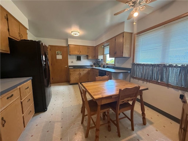 1180 Sunset Dr, Latrobe, PA 15650 - kitchen with freestanding refrigerator, ceiling fan, light floors, and brown cabinets
