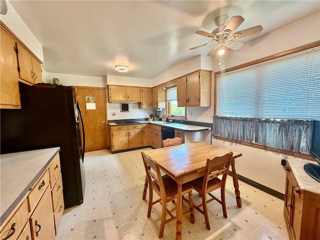 1180 Sunset Dr, Latrobe, PA 15650 - kitchen featuring black appliances, a ceiling fan, light flooring, and brown cabinets