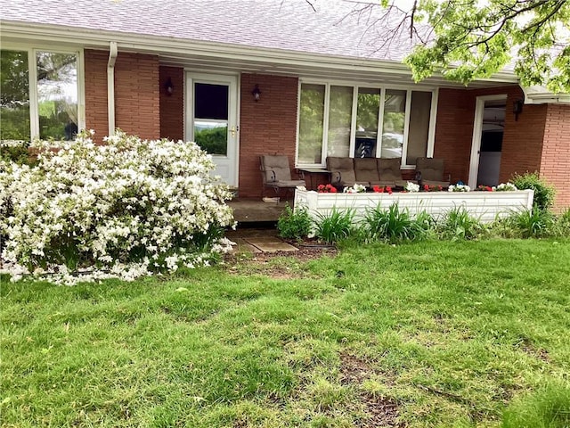 1180 Sunset Dr, Latrobe, PA 15650 - entrance to property featuring a lawn, a shingled roof, and brick siding